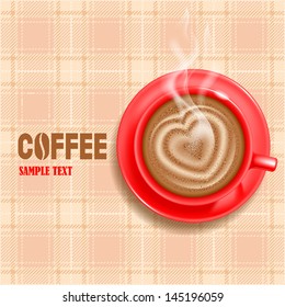 Cup of hot coffee on a table covered by tartan tablecloth