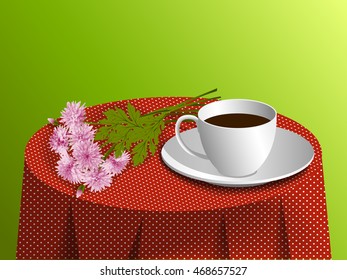 Cup and pink chrysanthemum on tablecloth