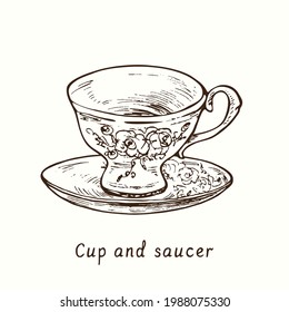 Cup and saucer with floral decor. Ink black and white drawing outline illustration