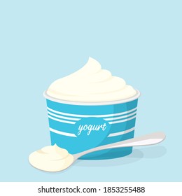 Cup and spoon with yogurt