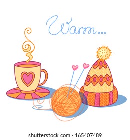 A cup of warm tea, a ball of wool and warm knitted cap with a pompon