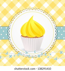 Cupcake with Yellow Icing on a Circular Label against a Yellow Gingham Background with Blue Ribbon