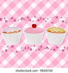 cupcakes decorated with icing and a cherry on a pink gingham background