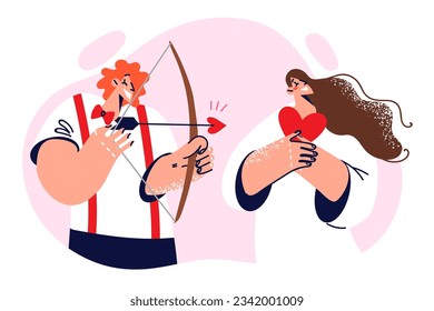 Cupid man with bow and arrows in hands stands near girlfriend experiencing romantic feelings. Guy in image of cupid wants to start relationship with girl and go on date or arrange wedding