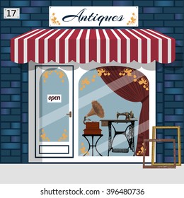 Curiosity shop (Antiques shop). Store facade. Gramophone and sewing machine in the window. Blue brick building. Vector illustration.