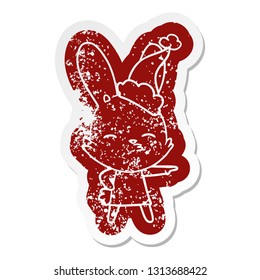 curious bunny quirky cartoon distressed sticker of a wearing santa hat