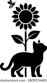 Curious kitten silhouette looking at a large sunflower