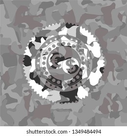 currency exchange icon inside grey camouflaged emblem