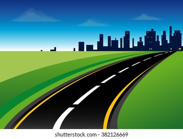 Curved asphalt road that leads to the city situated on the horizon line through the green fields
