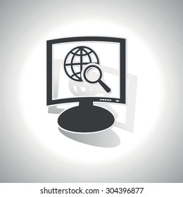Curved monitor with image of globe under loupe and shadow, on white