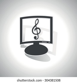 Curved monitor with image of treble clef and shadow, on white