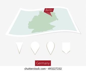 Curved paper map of Germany with capital Berlin on Gray Background. Four different Map pin set. Vector Illustration.