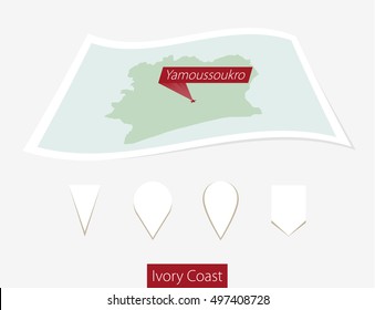Curved paper map of Ivory Coast with capital Yamoussoukro on Gray Background. Four different Map pin set. Vector Illustration.