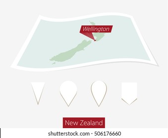 Curved paper map of New Zealand with capital Wellington on Gray Background. Four different Map pin set. Vector Illustration.