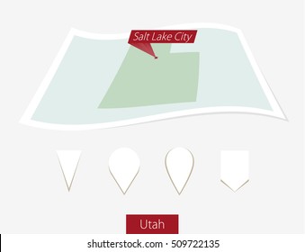 Curved paper map of Utah state with capital Salt Lake City on Gray Background. Four different Map pin set. Vector Illustration.
