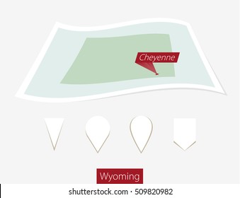 Curved paper map of Wyoming state with capital Cheyenne on Gray Background. Four different Map pin set. Vector Illustration.