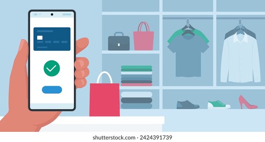 Customer using a mobile wallet app on his smartphone in a clothing store