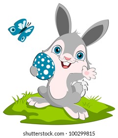 Cut Easter bunny holding a blue spotted egg and smiling. A blue butterfly in the background. Cartoon character.