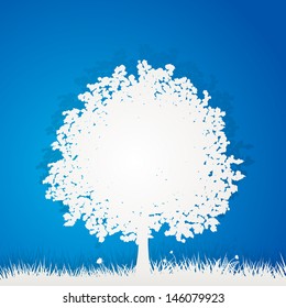 Cut Out Paper Tree and Grass on a Blue Background