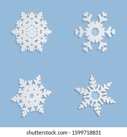 Cut out snowflakes. White patterns template of New Year or Christmas decorations. Background for scrapbooking, design elements, greeting paper cards and other holiday media. Vector illustration set.