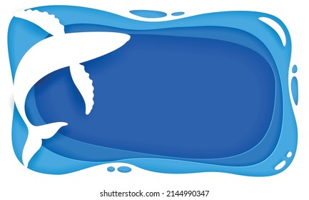 Cut paper depicting a blue whale swimming in the sea.