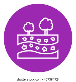 Cut of soil with different layers and trees on top line icon.