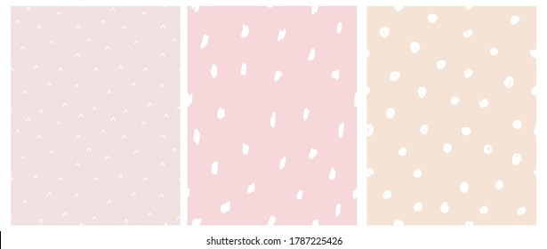 Cute Abstract Geometric Vector Patterns. White Irregular Brush Scribbles and Dots on a Light Pink and Cream Backgrounds. Lovely Pastel Color Delicate Layouts. Doodle Print.Funny Infantile Style Design