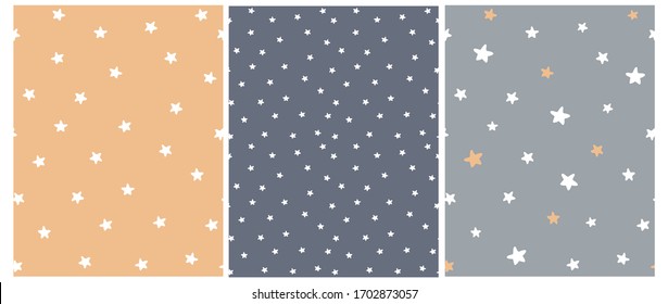 Cute Abstract Starry Sky Seamless Vector Patterns. White Freehand Stars on a Gray, Graphite and Pale Orange Background. Simple Infantile Style Irregular Print with Funny Hand Drawn Stars.