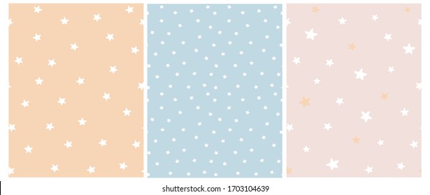 Cute Abstract Starry Sky Seamless Vector Patterns. White Freehand Stars on a Salmon, Light Blue and Pale Pink Background. Simple Infantile Style Irregular Print with Funny Hand Drawn Stars.