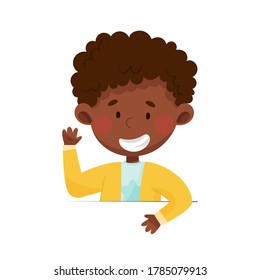 Cute African American Boy Character Sitting at Table or School Desk and Showing Greeting Gesture Vector Illustration
