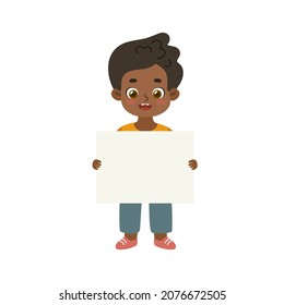Cute african american kid standing and holding empty banner. Adorable boy showing blank paper.