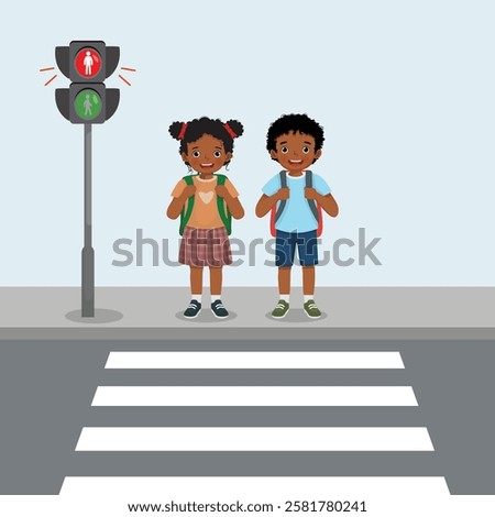 Cute African kids students with backpack waiting near stop sign on pedestrian traffic light to cross the road on zebra crossing on way to school
