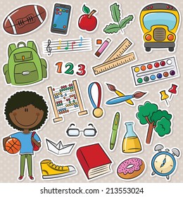 Cute African-American school boy with different education tools