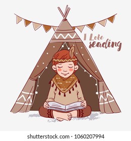 Cute American Indian boy in a tepee tent reading book