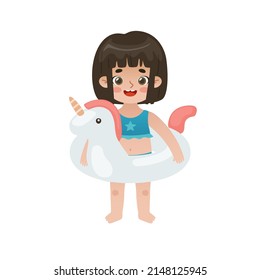 Cute asian girl standing with inflatable unicorn. Adorable baby girl on summer vacations with rubber ring.
