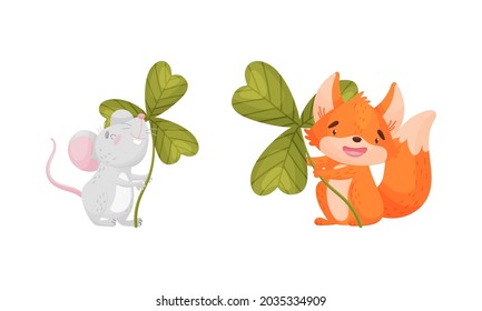 Cute baby animals with three leaf clover set. Adorable mouse, fox holding shamrock leaves cartoon vector illustration