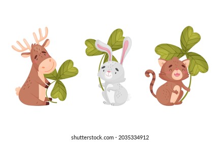 Cute baby animals with three leaf clover set. Adorable deer, bunny, cat holding shamrock leaves cartoon vector illustration