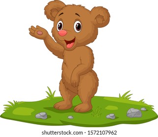 Cute baby bear waving hand on the grass