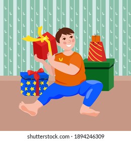 Cute baby boy on the floor with gift box in his hands.