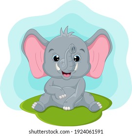 Cute baby elephant sitting in the grass