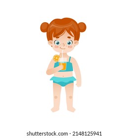 Cute baby girl standing and drinking orange juice. Adorable child with red hair and freckles on summer vacations.