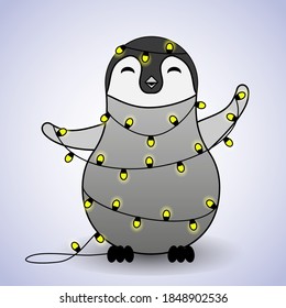 Cute baby penguin entangled in Christmas lanterns