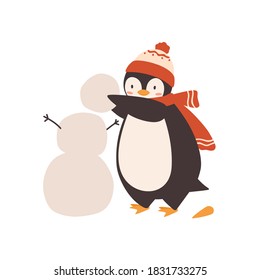 Cute baby penguin making snowman, holding snow ball vector flat illustration. Funny arctic bird wearing bobble hat and scarf isolated on white. Polar animal outdoor activity at winter day