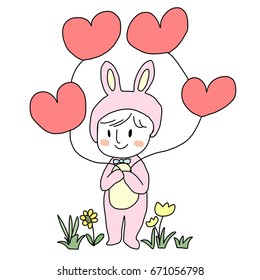 Cute baby wore animal costume. Little kid in rabbit costume standing and holding heart shape balloons among flowers field. Greeting card with cute baby concept or baby shower invitation.