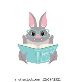 Cute bat in glasses reading a book, gray funny creature cartoon character vector Illustration on a white background