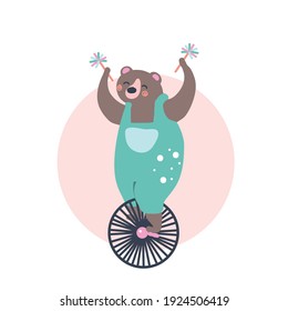 Cute bear in a circus on a bicycle