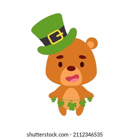 Cute bear in St. Patrick's Day leprechaun hat holds shamrocks. Irish holiday folklore theme. Cartoon design for cards, decor, shirt, invitation. Vector stock illustration.