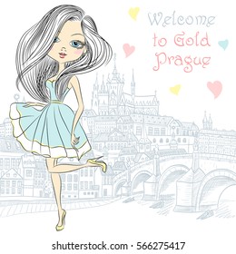 Cute beautiful fashionable girl in blue dress in Prague. Prague Castle and Charles Bridge on the background.