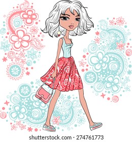 Cute beautiful fashionable hipster girl in a skirt and t-shirt with bag and pattern of doodles and flowers