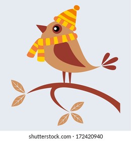 Cute bird with scarf and cap sitting on branch in the autumn.